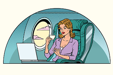 Image showing Businesswoman in business class of the aircraft works at a lapto