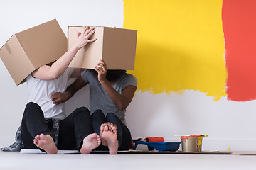 Image showing young multiethnic couple playing with cardboard boxes