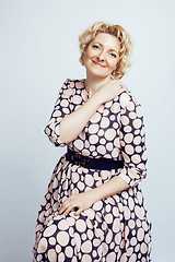 Image showing mature blond curly woman cheerful posing on white background isolated, lifestyle people concept 