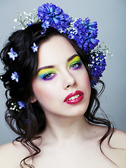 Image showing Beauty young woman with flowers and make up close up, real sprin