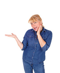 Image showing Smiling blond woman pointing.