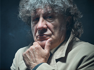 Image showing The senior man as detective or boss of mafia on gray studio background