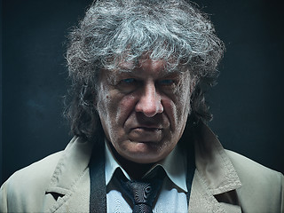 Image showing The senior man as detective or boss of mafia on gray studio background