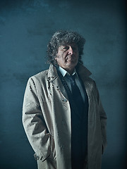 Image showing The senior man as detective or boss of mafia on gray studio background