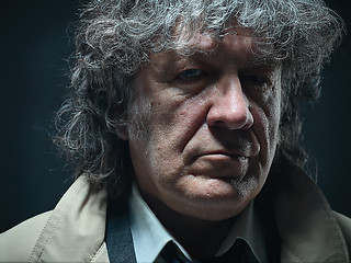 Image showing The senior man as detective or boss of mafia on gray studio background