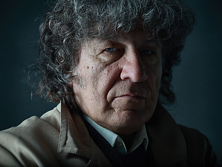 Image showing The senior man as detective or boss of mafia on gray studio background