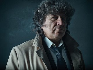 Image showing The senior man as detective or boss of mafia on gray studio background