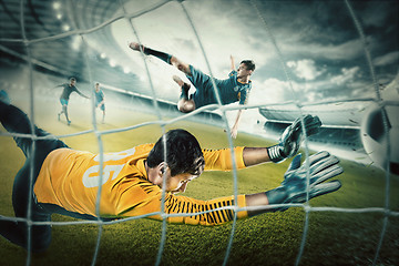 Image showing Goalkeeper in gates jumping to catching ball