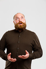 Image showing Man with beard looks up