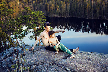 Image showing middle age man with little cute son doing sport yoga on the top of the mountain together, happy family lifestyle people outdoor, summer wild nature for training