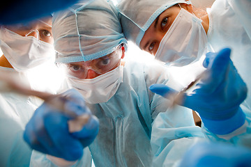 Image showing Surgeons holding instruments in hands