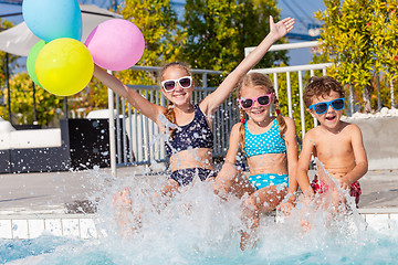 Image showing happy children  playing on the swimming pool at the day time.