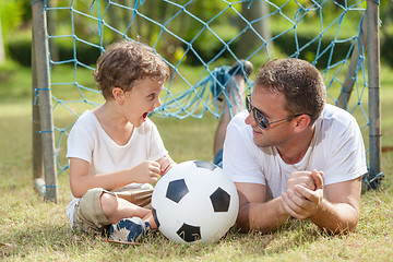 Image showing Father and son playing in the park  at the day time.