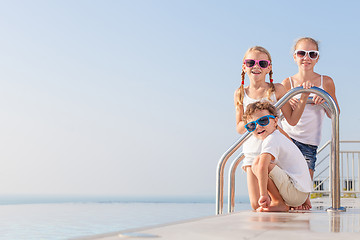 Image showing happy children  playing on the swimming pool at the day time.