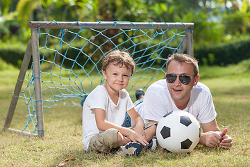 Image showing Father and son playing in the park  at the day time.