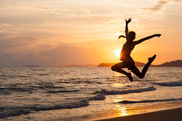 Image showing Happy girl jumping on the beach