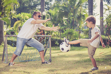 Image showing Father and son playing in the park  at the day time.