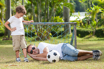 Image showing Father and son playing in the park  at the day time.