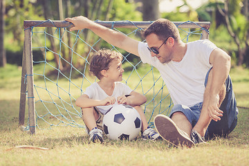 Image showing Father and son playing in the park  at the day time.