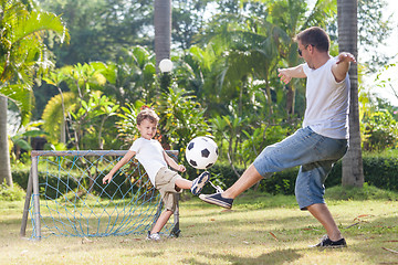 Image showing Father and son playing in the park  at the day time.