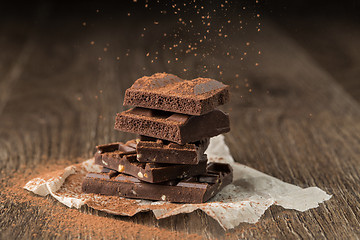 Image showing Pieces of chocolate sprinkled cocoa