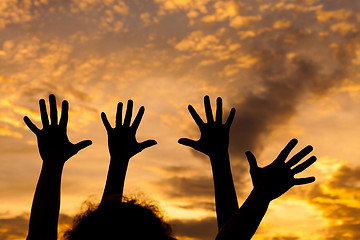 Image showing silhouette of female hands during sunset. 