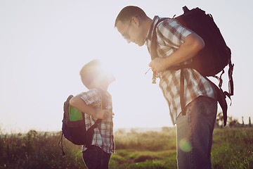 Image showing Father and son playing in the park at the sunset time.