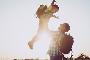 Image showing Father and son playing in the park at the sunset time.