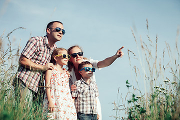 Image showing Happy family walking on the field at the day time.