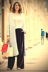 Image showing beautiful woman with shopping bags in a big store