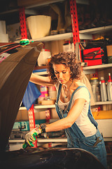 Image showing Beautiful woman automechanic in blue overall 