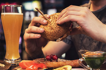 Image showing Man eating burgers