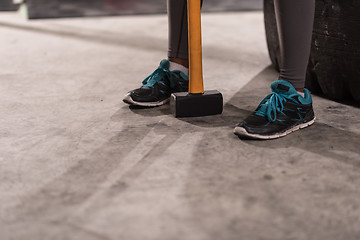 Image showing black woman after workout with hammer with focus on legs