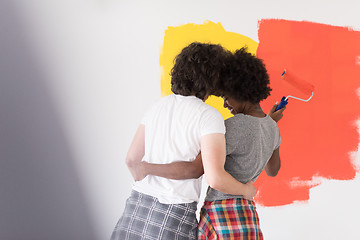 Image showing multiethnic couple painting interior wall