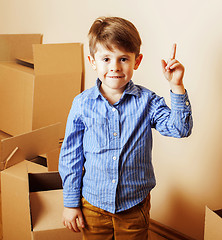 Image showing little cute boy in empty room, remoove to new house. home alone 