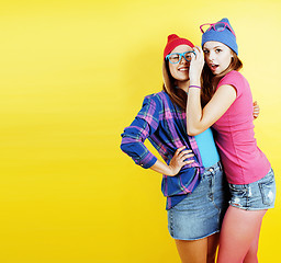 Image showing lifestyle people concept: two pretty young school teenage girls having fun happy smiling on yellow background