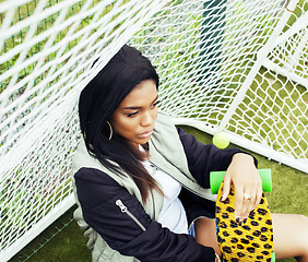 Image showing cool pretty smiling afro-american happy young woman with skate b