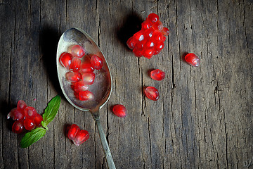 Image showing Ripe pomegranate and spoon 