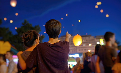 Image showing Teens watching paper flying lanterns