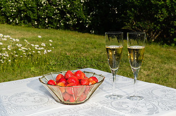 Image showing Bowl with strawberries and two glasses with champagne