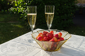 Image showing Two glasses with champagne and strawberries