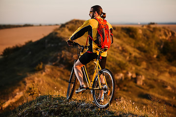 Image showing Sporty Man Riding a Bicycle on the Country Road.