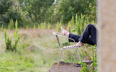 Image showing Feet of a woman relaxing in her yard, Iceland