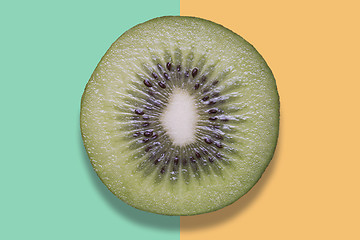 Image showing Piece of kiwi on colorful background