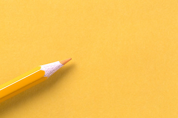 Image showing Yellow crayon on yellow paper