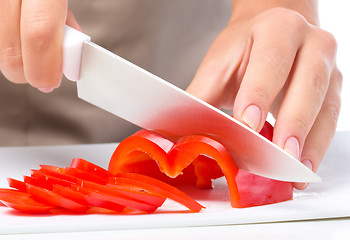 Image showing Cook is chopping bell pepper