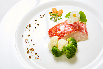 Image showing The red snapper with vegetable. Shallow dof.