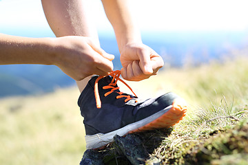 Image showing Tying shoelaces.