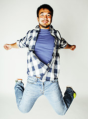 Image showing young pretty asian man jumping cheerful against white background