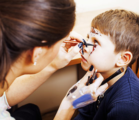 Image showing little cute child making facepaint on birthday party, zombie Apo